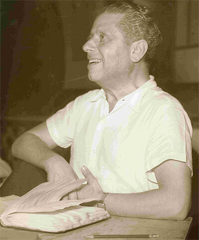 Photo of Max Reinhardt with one of his promptbooks in front of him